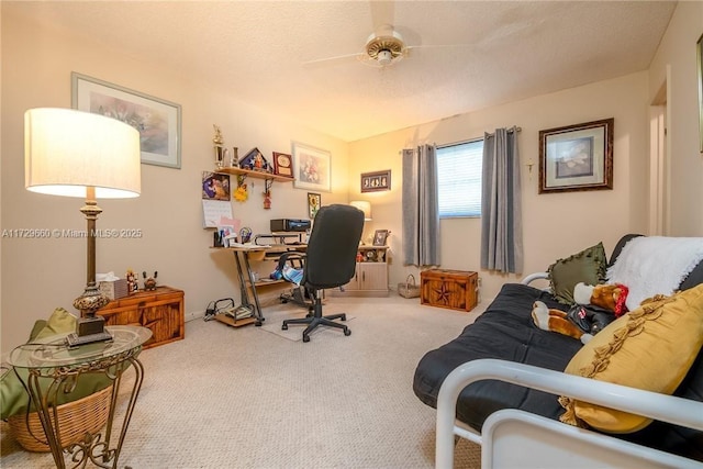 carpeted home office featuring a textured ceiling