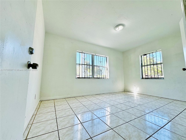 empty room with light tile patterned flooring