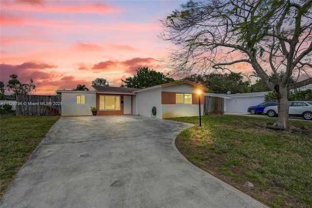 ranch-style home with a lawn