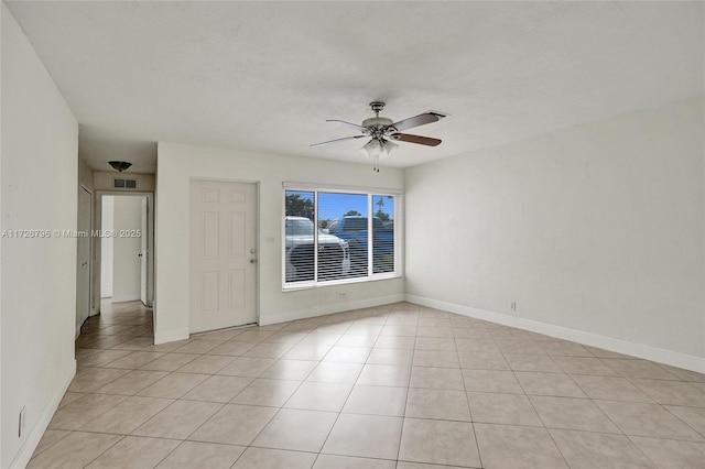 spare room featuring ceiling fan and light tile patterned floors