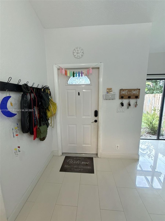 foyer featuring light tile patterned floors