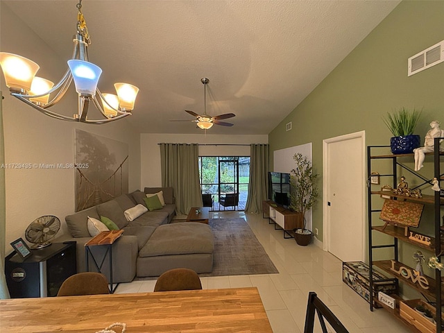 tiled living room with vaulted ceiling, ceiling fan with notable chandelier, and a textured ceiling