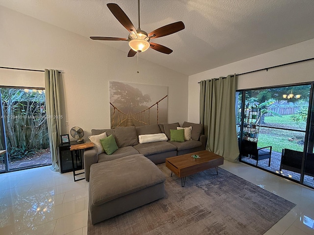 tiled living room with vaulted ceiling, ceiling fan, and a textured ceiling