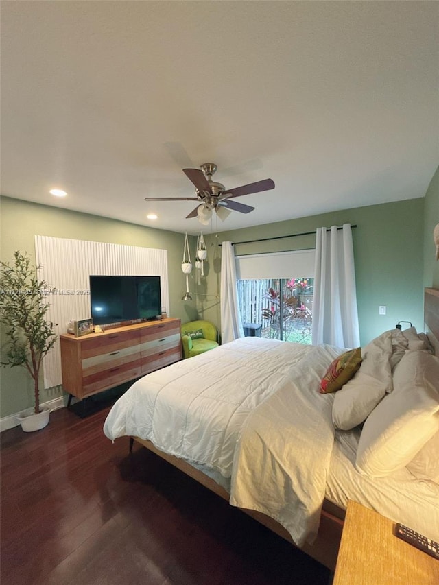 bedroom with dark hardwood / wood-style flooring and ceiling fan