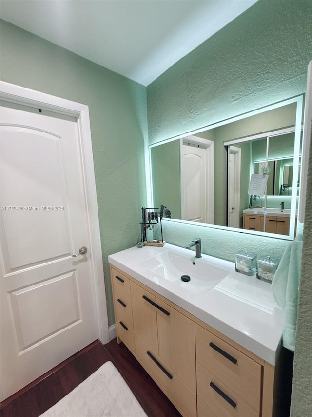 bathroom featuring wood-type flooring and vanity