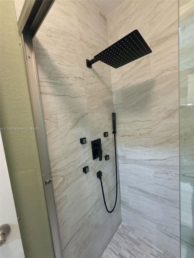 bathroom with tiled shower