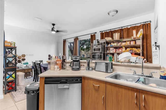 kitchen featuring ceiling fan, sink, stainless steel appliances, and light tile patterned flooring