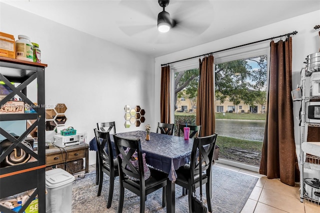 dining room featuring ceiling fan and light tile patterned flooring