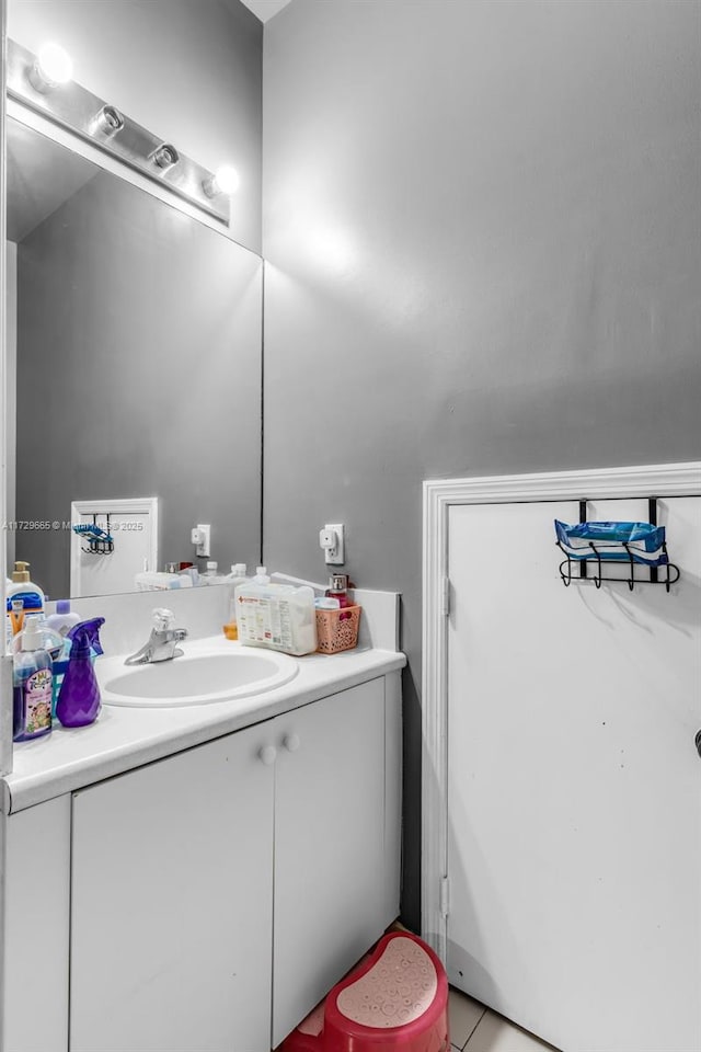 bathroom featuring tile patterned flooring and vanity