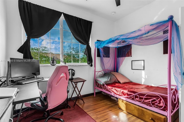 bedroom with ceiling fan and hardwood / wood-style flooring