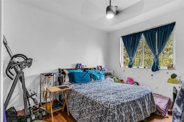 bedroom with ceiling fan and hardwood / wood-style floors