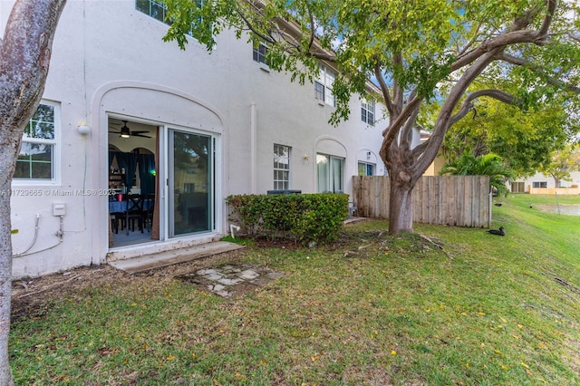 rear view of house featuring a yard