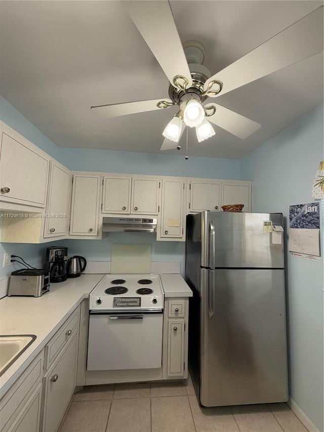 kitchen featuring ceiling fan, electric stove, light tile patterned floors, and stainless steel refrigerator