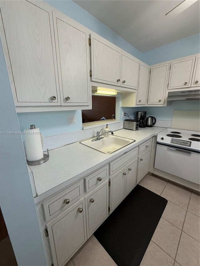 kitchen featuring light tile patterned floors, sink, and electric stove