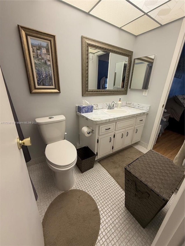 bathroom with tile patterned floors, vanity, and toilet