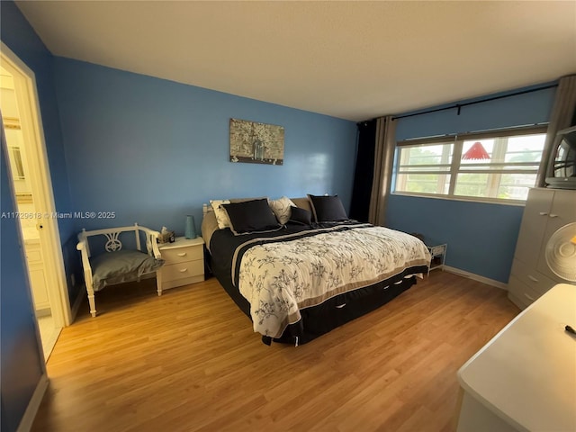 bedroom with light hardwood / wood-style flooring