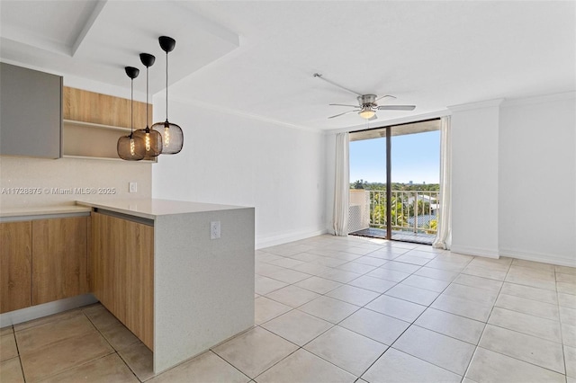 kitchen featuring pendant lighting, light tile patterned flooring, ceiling fan, expansive windows, and crown molding