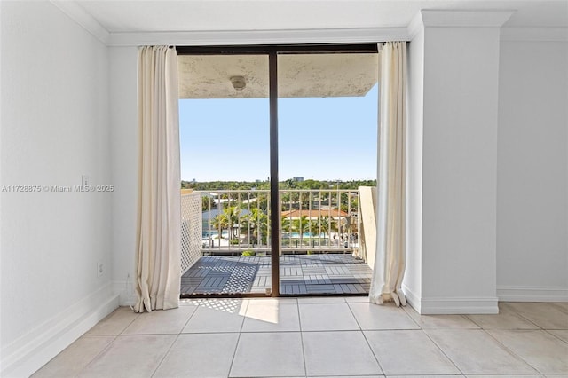 doorway to outside with light tile patterned floors and crown molding