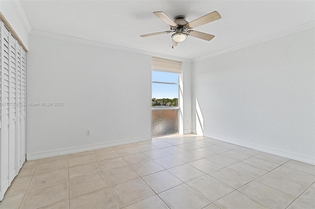 tiled spare room with ceiling fan and crown molding