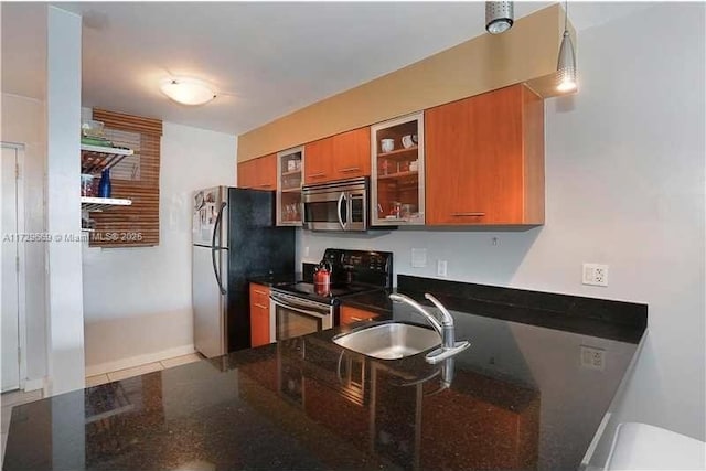 kitchen with light tile patterned floors, sink, and stainless steel appliances