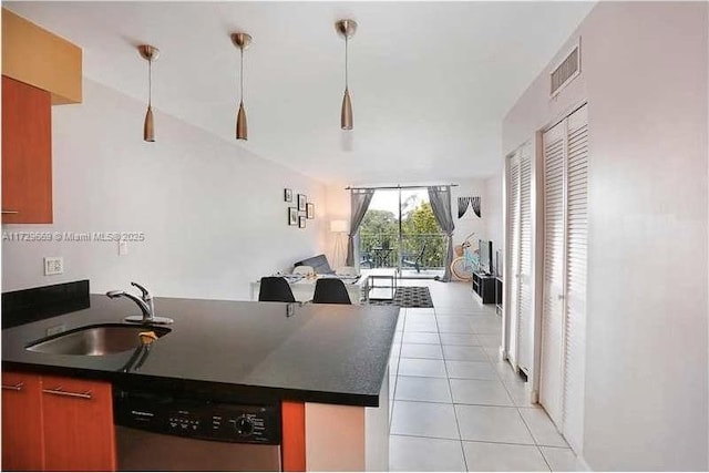 kitchen featuring light tile patterned flooring, dishwasher, pendant lighting, expansive windows, and sink