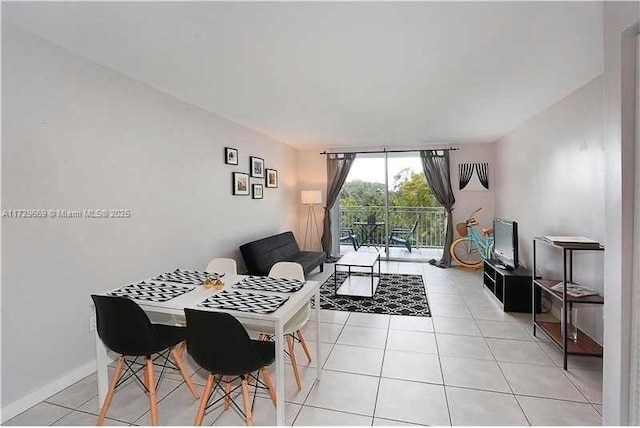 dining area featuring expansive windows and light tile patterned flooring