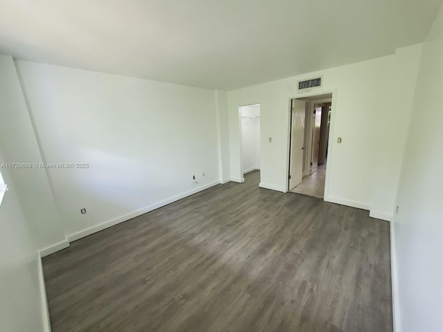 unfurnished room featuring dark hardwood / wood-style flooring