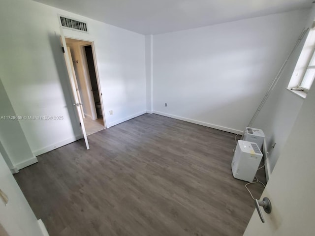 empty room with dark hardwood / wood-style floors