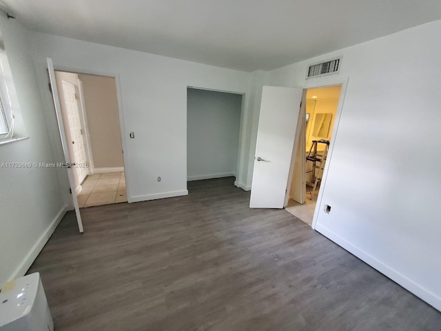 unfurnished bedroom with dark hardwood / wood-style floors