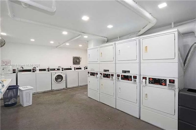 laundry room with stacked washing maching and dryer and washing machine and clothes dryer