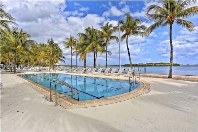 view of swimming pool with a water view