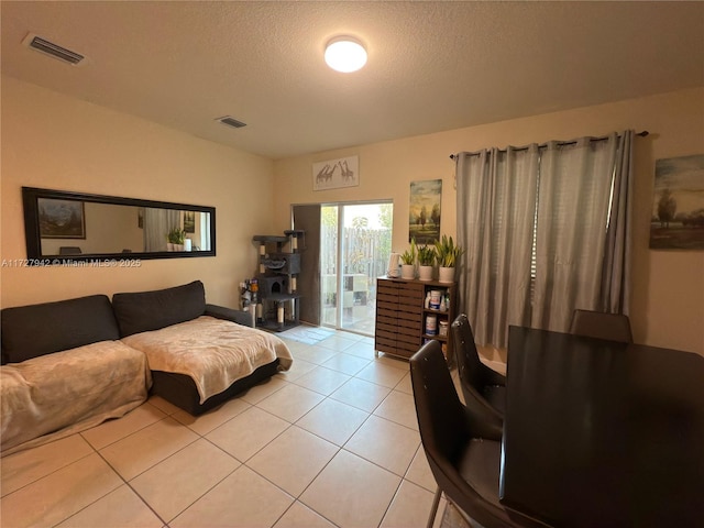 tiled living room with a textured ceiling