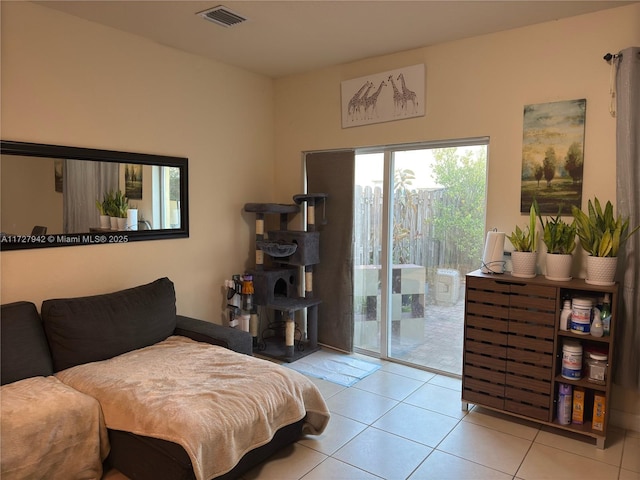 tiled bedroom featuring access to outside