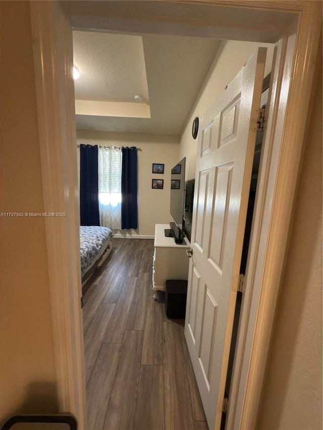 hallway with wood-type flooring