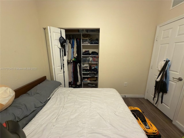 bedroom with a closet and dark hardwood / wood-style flooring