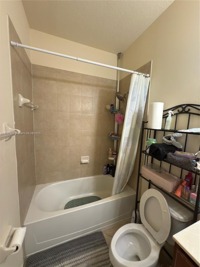 bathroom featuring toilet, tile patterned floors, shower / bath combo, and a textured ceiling