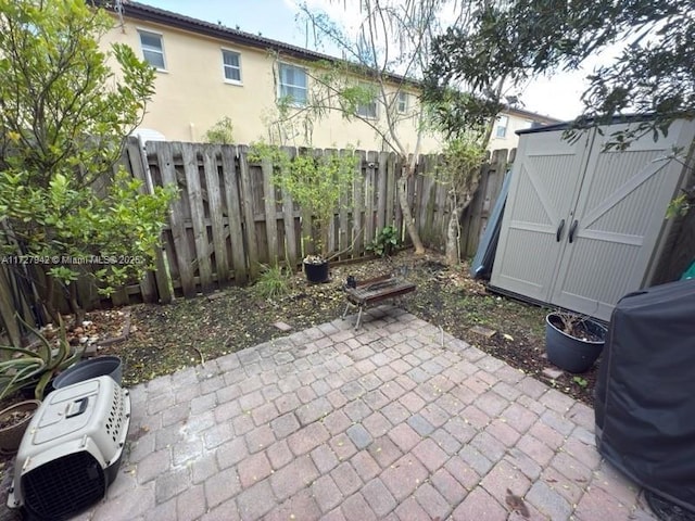 view of patio with grilling area and a storage unit