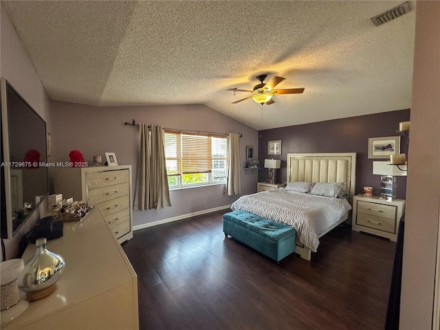 bedroom with ceiling fan, a textured ceiling, dark hardwood / wood-style flooring, and lofted ceiling