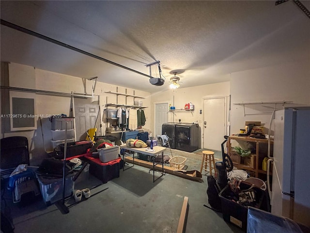 garage featuring a garage door opener and white refrigerator