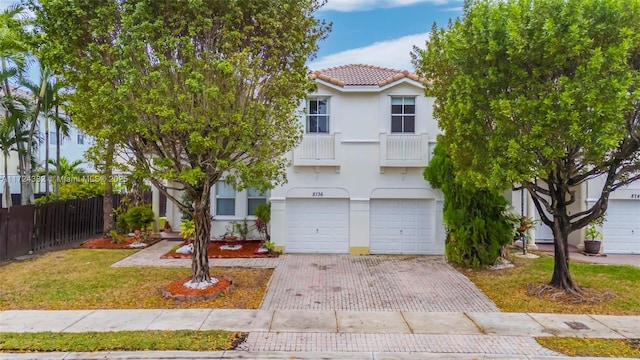 view of front of house with a front yard and a garage