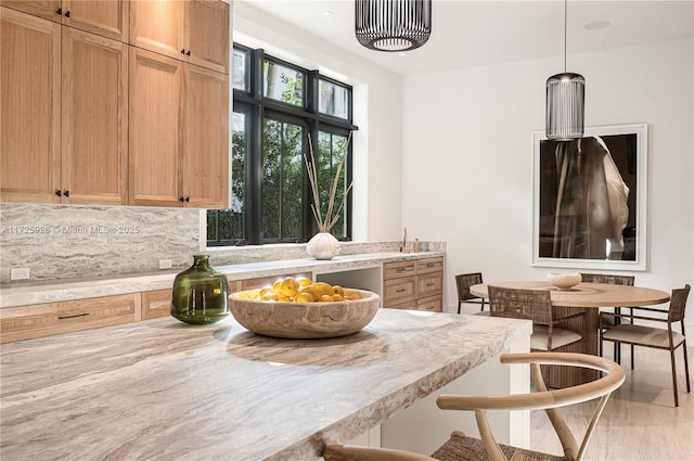 kitchen featuring pendant lighting and backsplash