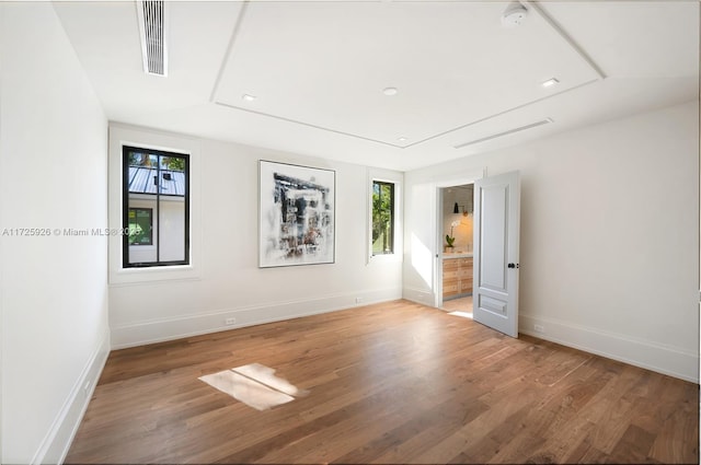 unfurnished bedroom with hardwood / wood-style floors and vaulted ceiling