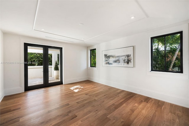 unfurnished room with hardwood / wood-style floors and french doors