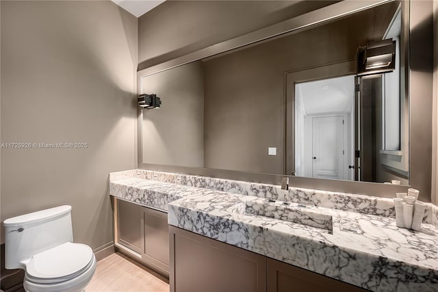 bathroom featuring toilet and vanity