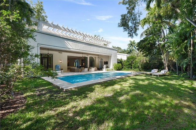 view of pool with ceiling fan, a yard, an outdoor hangout area, and a patio