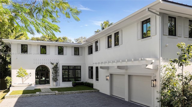 view of front of home with a garage and french doors