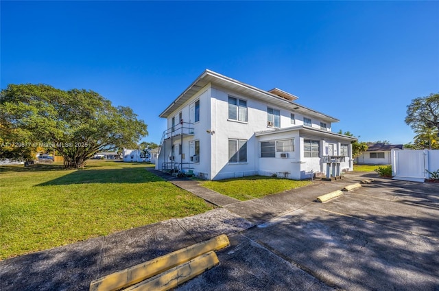 view of side of property with a lawn