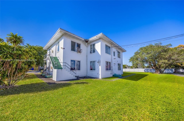 back of property featuring a lawn