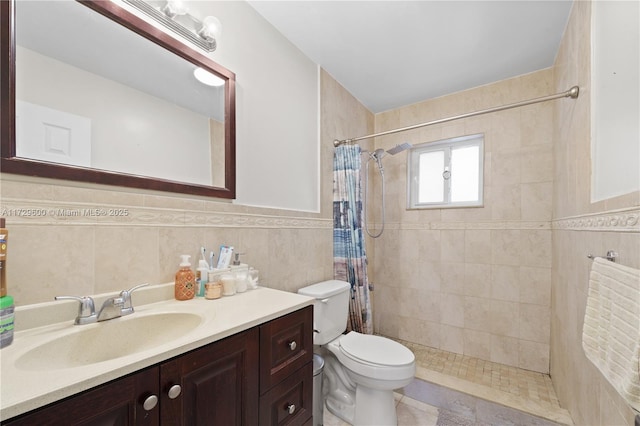 bathroom with tile walls, toilet, vanity, and walk in shower