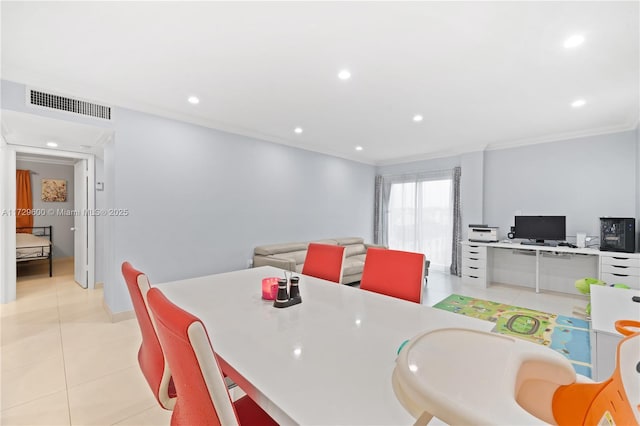 tiled dining space featuring crown molding